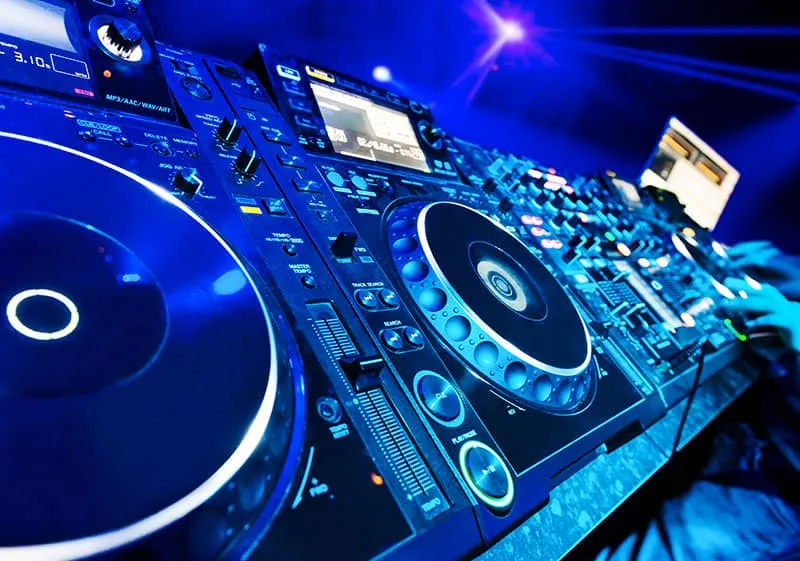 Photo of DJ equipment in a club environment