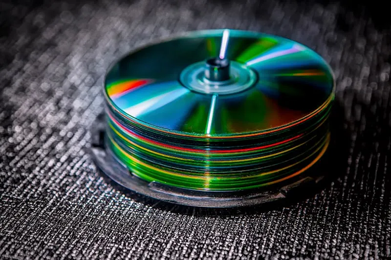 Pile of CDs on a dark background.