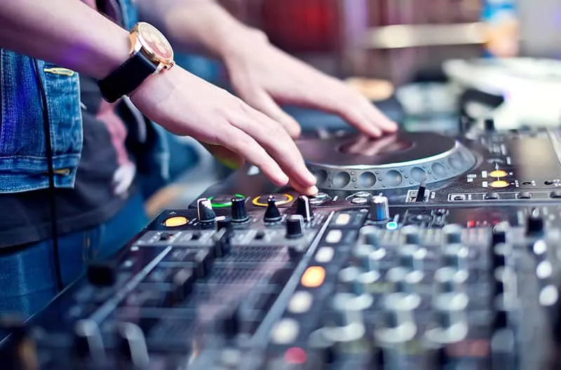 DJ playing with a DJ controllers jog wheel