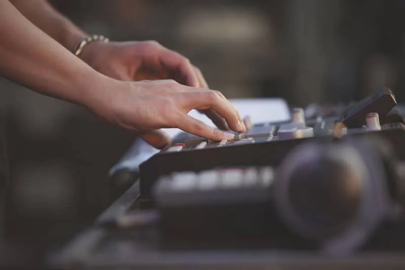 A DJ using a drum machine