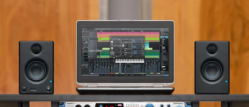 PreSonus Eris E3.5 monitors next to a laptop.