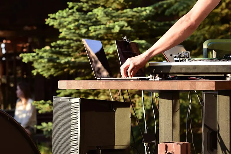 DJ performing outside with DJ speakers