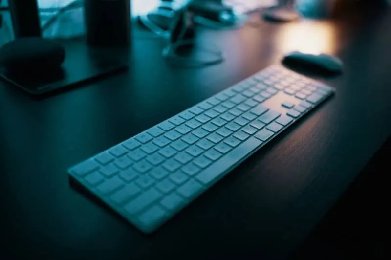 Photo of an office workspace with a wireless keyboard and mouse.