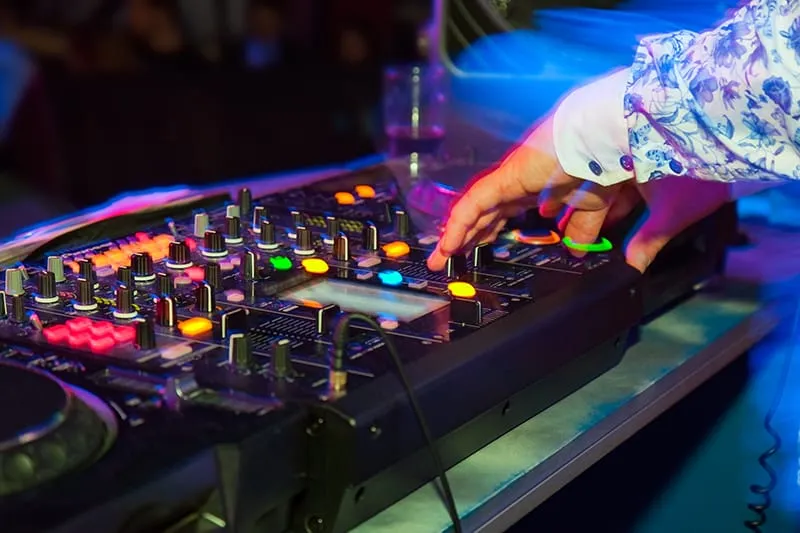 DJ playing at a nightclub on professional DJ gear.