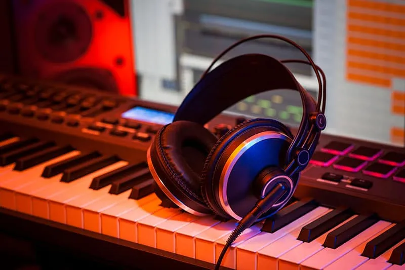 Headphones sitting on a keyboard.