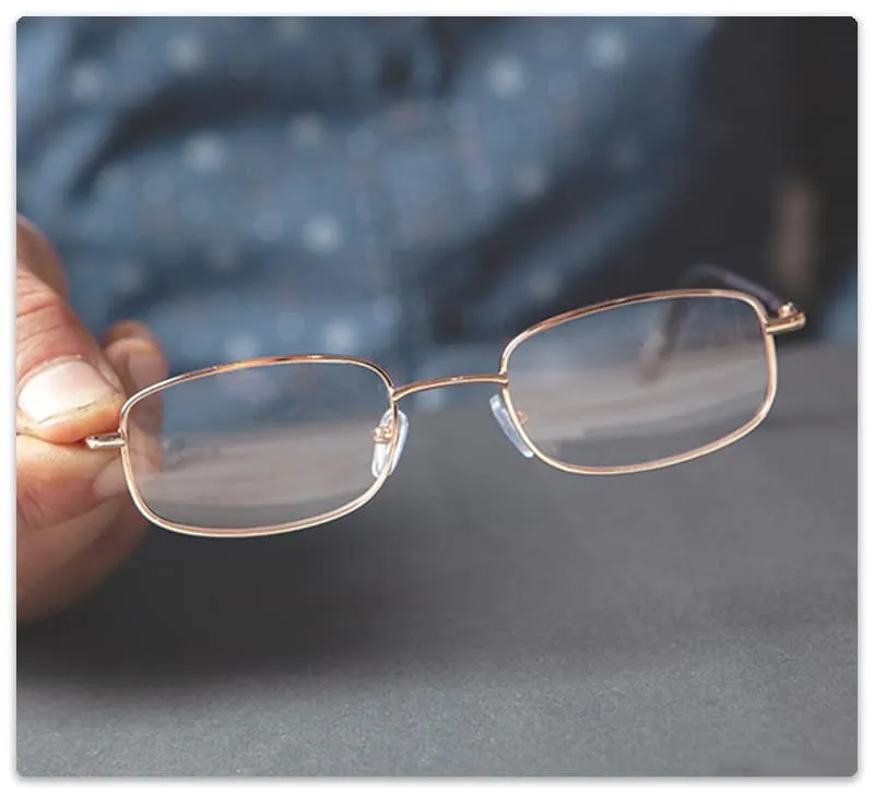 Close up photo of a pair of glasses with thin frames.