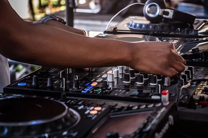 DJ performing using a DJ mixer.