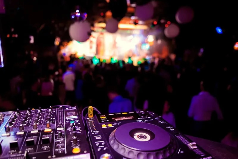 DJ gear overlooking a crowd at a nightclub