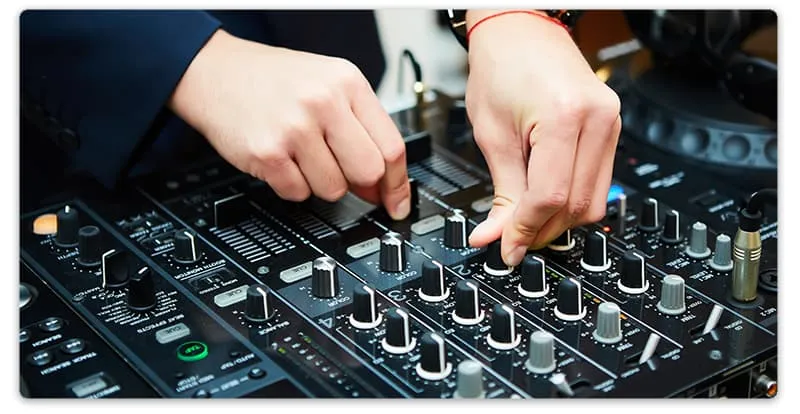 Close-up photo of a DJ using a mixer.