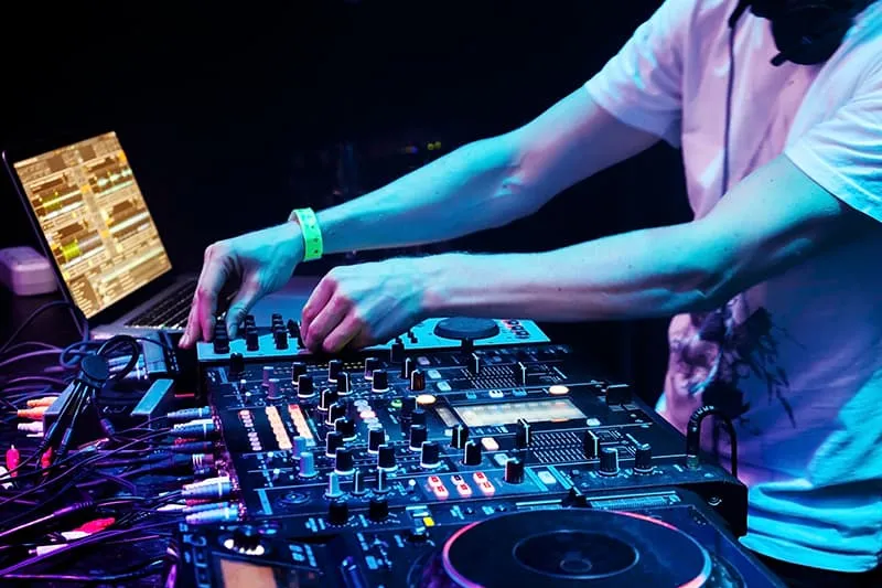 DJ using DJ software and DJ equipment