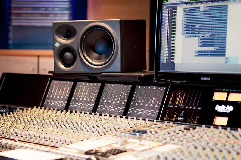 Neumann studio monitor on its side in a music studio.