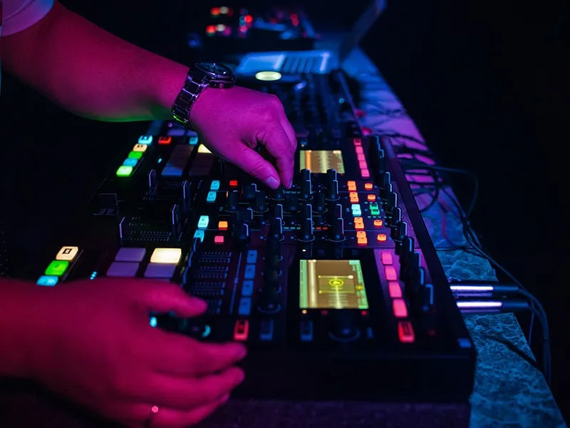 DJ using Native Instruments DJ gear at a club.