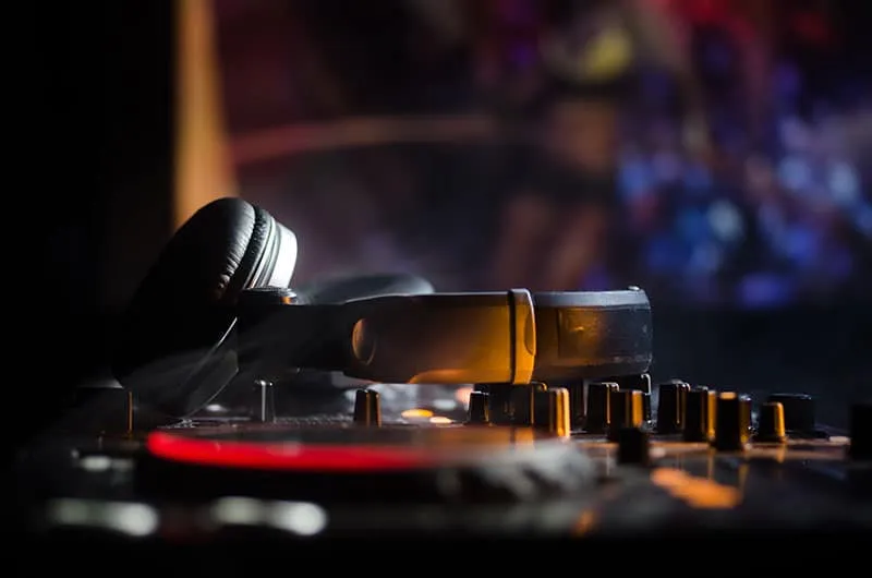 Headphones sitting on top of DJ equipment