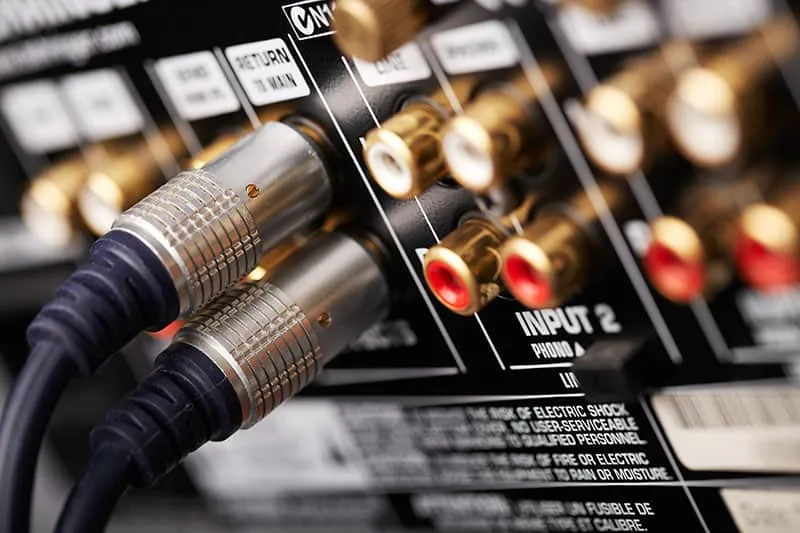 Audio cables connected to DJ equipment.