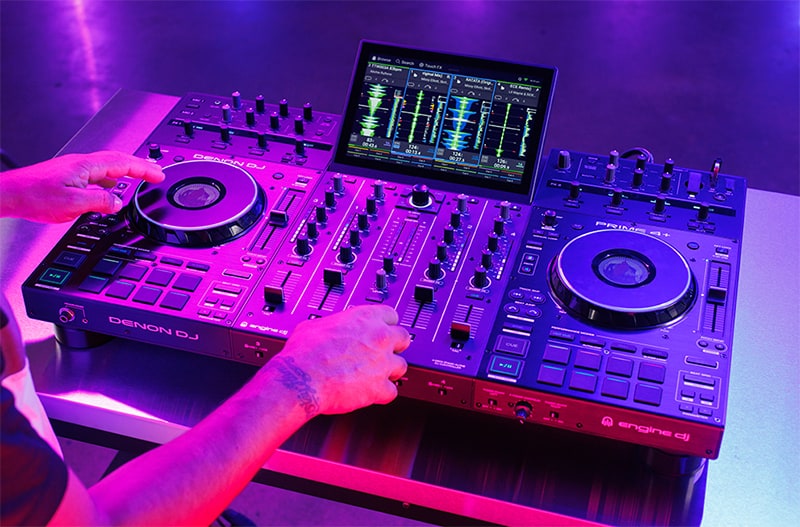DJ using the Denon Prime 4 Plus in a studio.